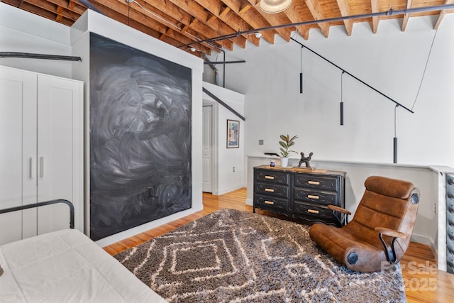 sitting room with light wood-type flooring, beam ceiling, and wooden ceiling