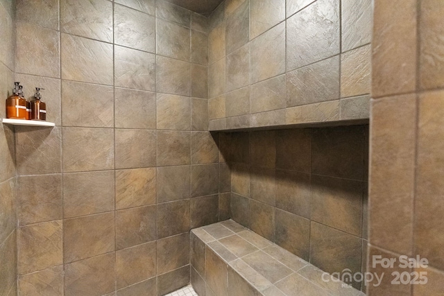 bathroom with a tile shower