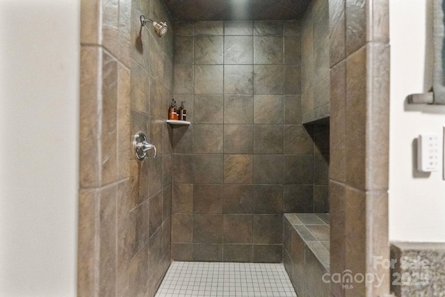 bathroom with a tile shower