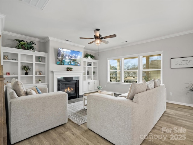 living room with crown molding, ceiling fan, and light hardwood / wood-style floors