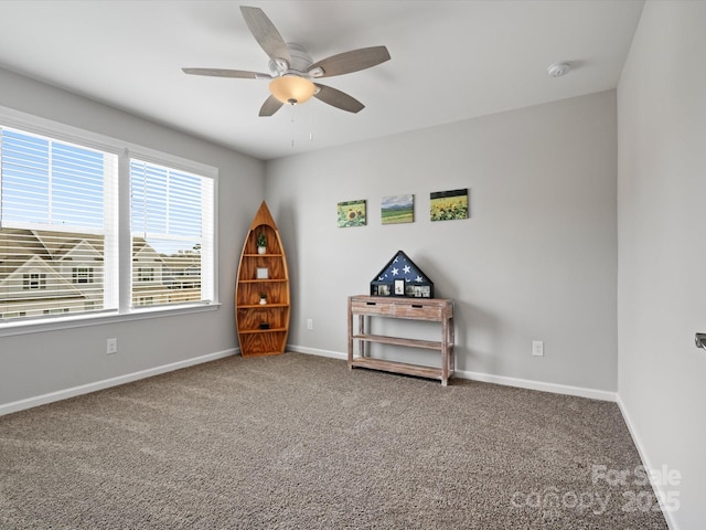 interior space with carpet flooring and ceiling fan