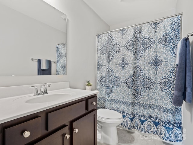 bathroom featuring vanity, toilet, and tile patterned flooring