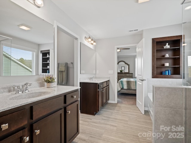 bathroom featuring vanity, a bathing tub, and built in features