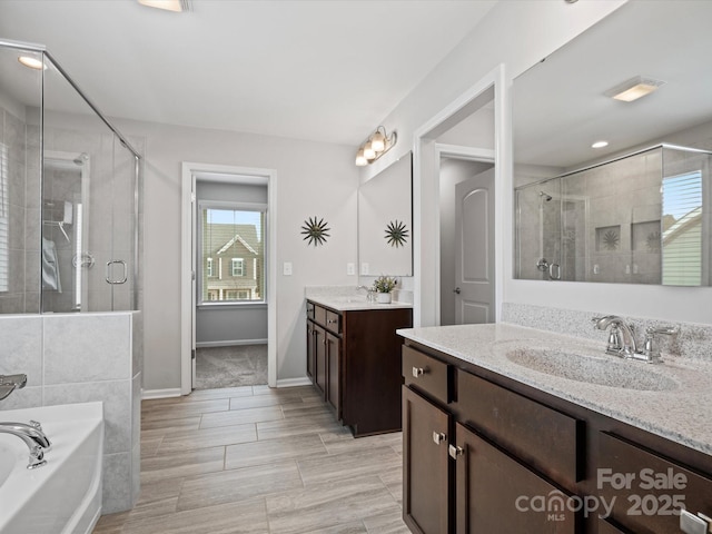 bathroom with vanity and independent shower and bath