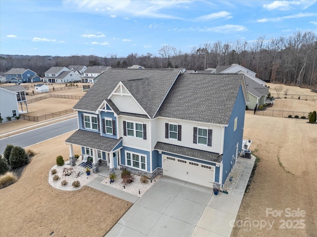 view of front of property with cooling unit, a porch, and a garage