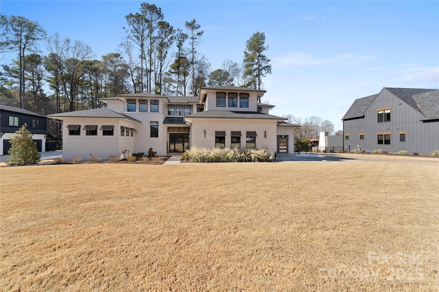 rear view of house featuring a lawn