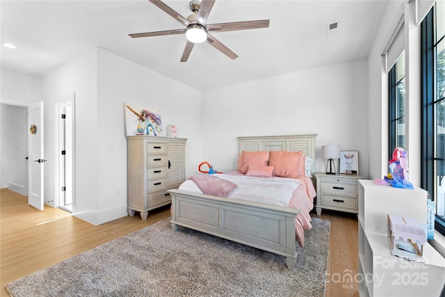 bedroom with ceiling fan and hardwood / wood-style floors