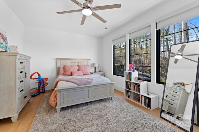 bedroom with ceiling fan and light hardwood / wood-style floors