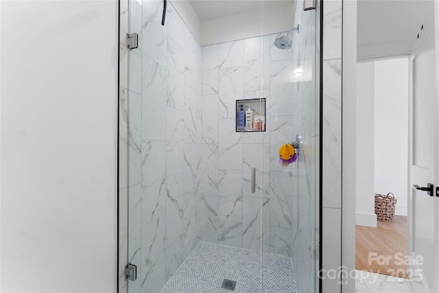 bathroom featuring hardwood / wood-style floors and walk in shower