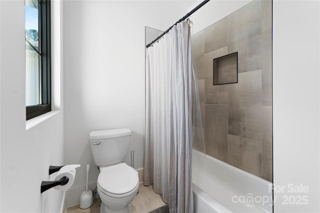 bathroom featuring toilet and shower / bath combo