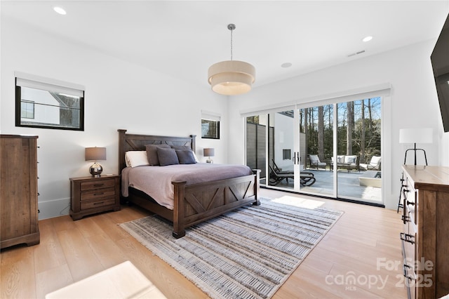 bedroom with light hardwood / wood-style floors and access to exterior