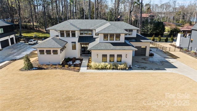 view of front of house with a front yard and a garage