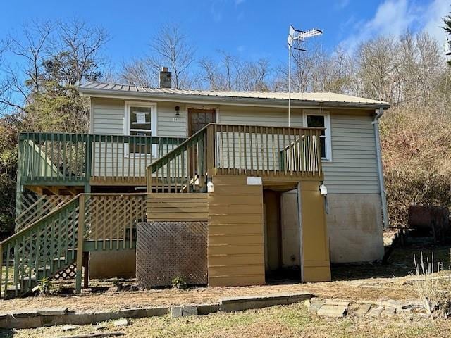 rear view of property with a wooden deck