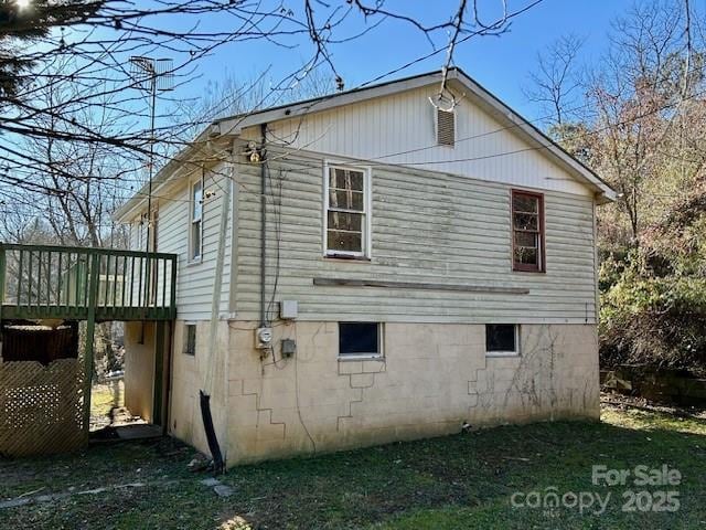 view of side of home featuring a deck