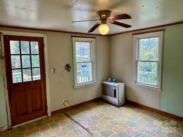 doorway featuring ceiling fan and heating unit