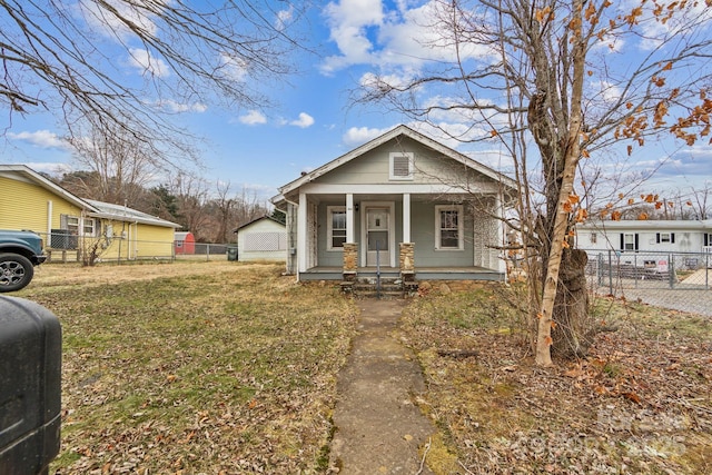 bungalow featuring a front lawn and a porch