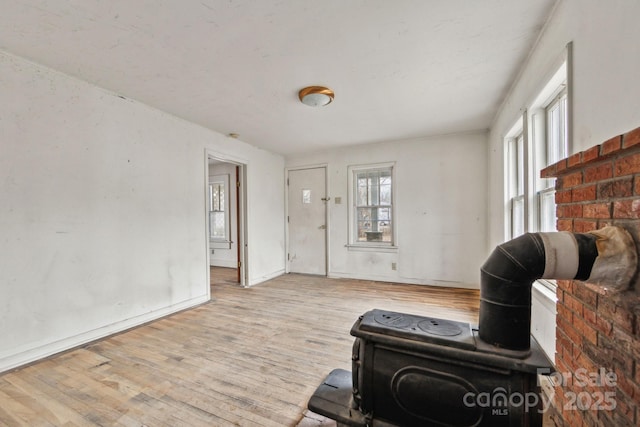 living room with light hardwood / wood-style floors and a healthy amount of sunlight