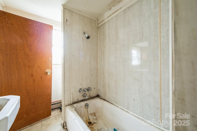 bathroom with tile patterned floors, a bathtub, and baseboard heating