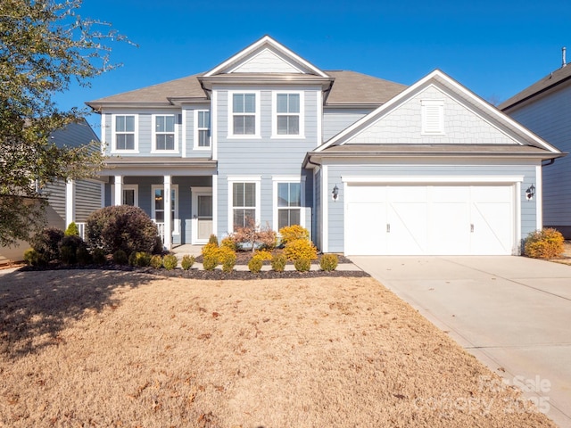 view of front of house with a porch and a garage