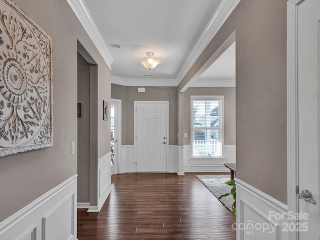 entryway featuring ornamental molding and dark hardwood / wood-style flooring