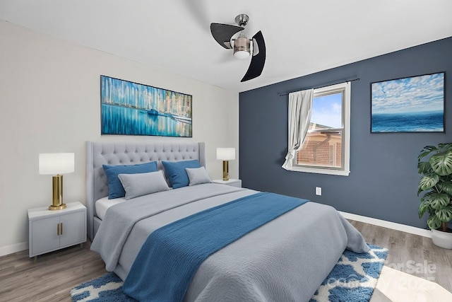 bedroom with wood-type flooring and ceiling fan