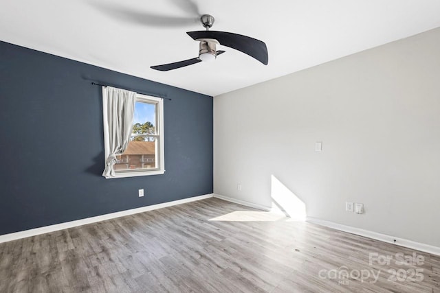 spare room with wood-type flooring and ceiling fan