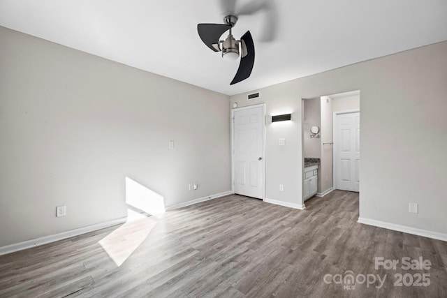 unfurnished bedroom featuring hardwood / wood-style flooring and ceiling fan