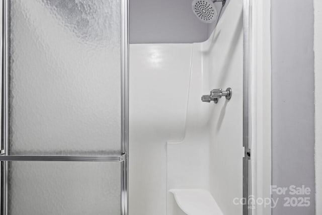 bathroom with a shower with shower door