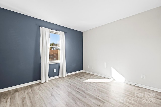 spare room with light hardwood / wood-style flooring