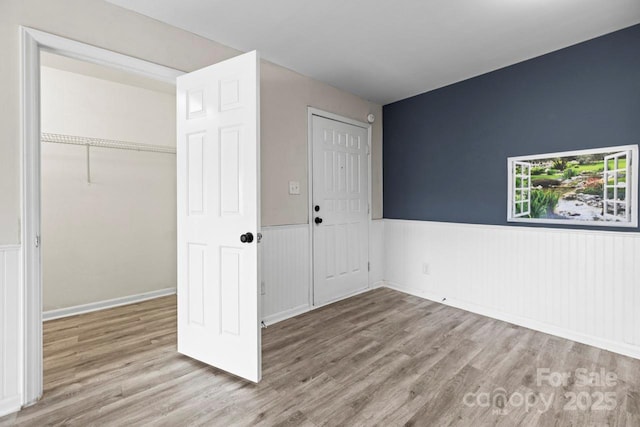 unfurnished bedroom with light hardwood / wood-style floors and a closet