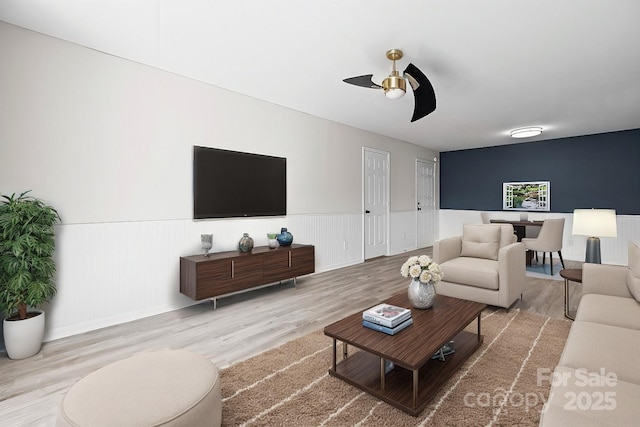 living room with wood-type flooring and ceiling fan