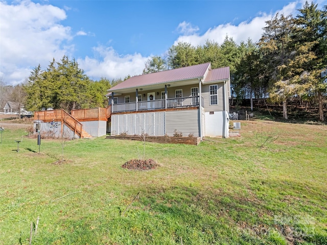 view of front of home with a wooden deck and a front yard