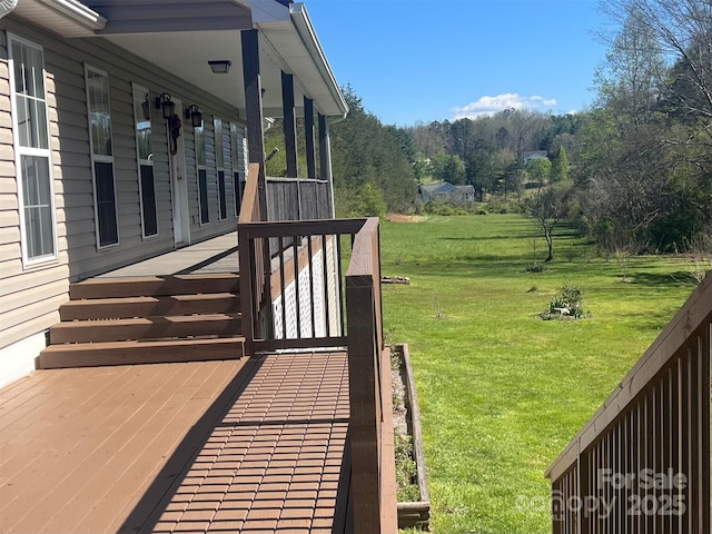 wooden terrace with a yard