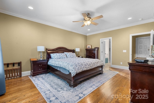 bedroom featuring ceiling fan, ornamental molding, and light hardwood / wood-style flooring