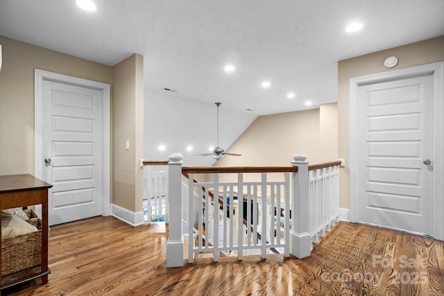 corridor featuring hardwood / wood-style floors and vaulted ceiling