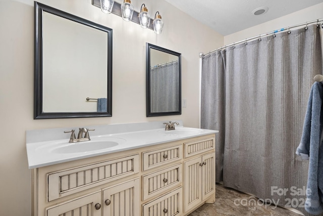 bathroom featuring a shower with shower curtain and vanity