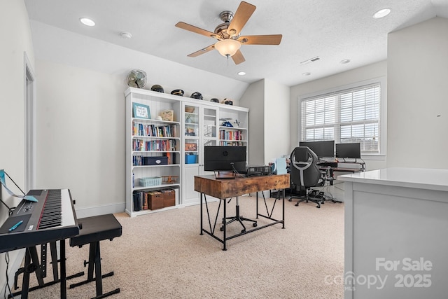 carpeted home office featuring ceiling fan, vaulted ceiling, and a textured ceiling