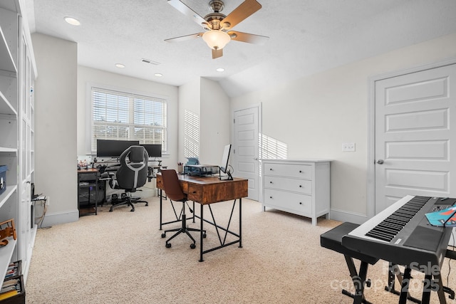 carpeted home office with lofted ceiling, a textured ceiling, and ceiling fan