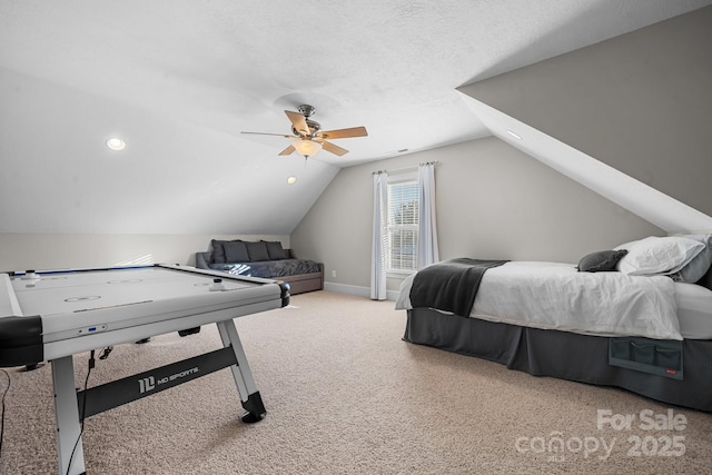 bedroom featuring lofted ceiling, light carpet, a textured ceiling, and ceiling fan