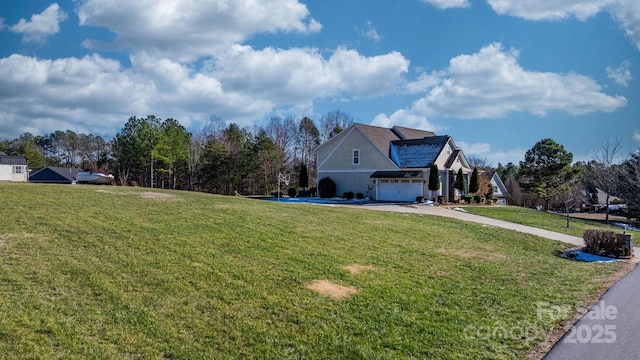 view of side of property featuring a yard and a garage