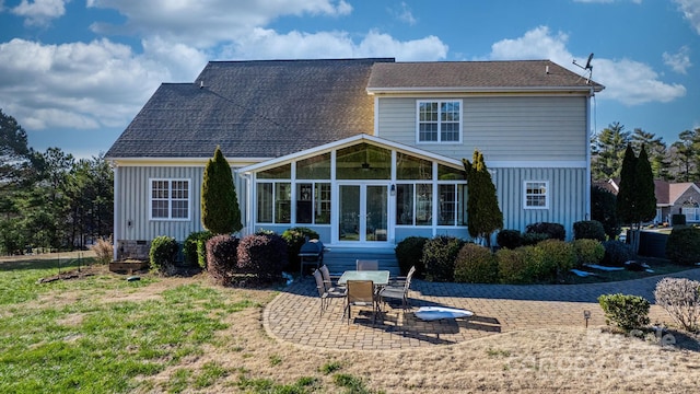 rear view of house featuring a patio, a sunroom, and a lawn