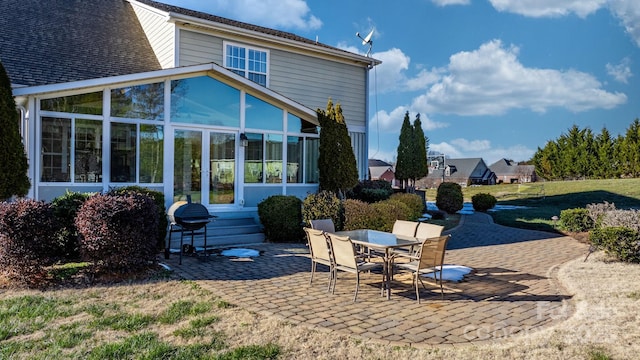 back of property featuring a patio and a sunroom