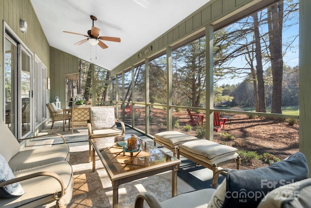 sunroom with ceiling fan and lofted ceiling