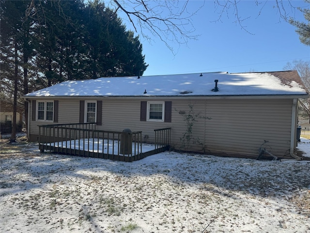 snow covered property featuring a wooden deck