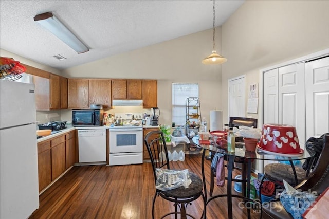 kitchen with a textured ceiling, white appliances, decorative light fixtures, high vaulted ceiling, and dark hardwood / wood-style floors