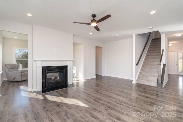 unfurnished living room with ceiling fan and dark hardwood / wood-style flooring