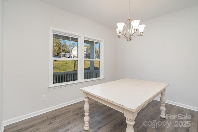 dining area featuring dark hardwood / wood-style flooring and a notable chandelier