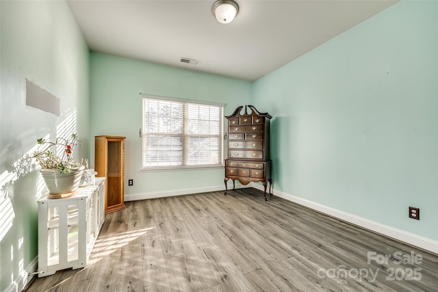 unfurnished room with light hardwood / wood-style floors