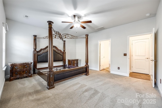 bedroom with ceiling fan, ensuite bath, and carpet flooring