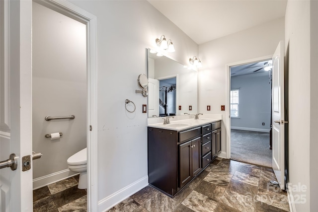 bathroom with ceiling fan, vanity, and toilet